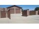 Home exterior with double garage doors and gated entrance at 7801 E Davenport Dr, Scottsdale, AZ 85260