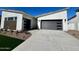 Modern home exterior with two-car garage and landscaped front yard at 3812 W Antelope Way, San Tan Valley, AZ 85144