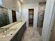 Modern bathroom with double vanity, marble flooring, and glass shower at 3812 W Antelope Way, San Tan Valley, AZ 85144