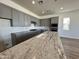 Modern kitchen with gray cabinets, quartz countertops, and white subway tile backsplash at 3812 W Antelope Way, San Tan Valley, AZ 85144