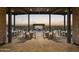 Large community patio with tables, chairs, and a screen at 3812 W Antelope Way, San Tan Valley, AZ 85144