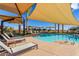 Community pool with shade umbrellas and lounge chairs at 10065 E Thatcher Ave, Mesa, AZ 85212