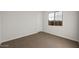 Well-lit bedroom featuring neutral walls and carpet at 22466 E San Tan Blvd, Queen Creek, AZ 85142