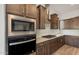 Modern kitchen with dark wood cabinets and stainless steel appliances at 22466 E San Tan Blvd, Queen Creek, AZ 85142