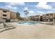 Community pool with lounge chairs and surrounding patio at 540 N May St # 3106, Mesa, AZ 85201