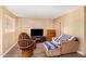 Living area featuring a comfy couch and a wood accent chair at 5546 E Player Pl, Mesa, AZ 85215
