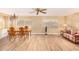 Living and dining area with wood-look floors and a striped sofa at 5546 E Player Pl, Mesa, AZ 85215
