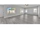 Spacious living room with hardwood floors, ceiling fan, and large windows at 2120 N 125Th Ave, Avondale, AZ 85392