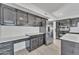 Well-equipped kitchen with dark cabinetry, quartz countertops, and built-in desk at 2120 N 125Th Ave, Avondale, AZ 85392