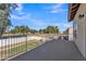 Back patio overlooks grassy backyard with mature trees and neighborhood view at 2120 N 125Th Ave, Avondale, AZ 85392