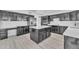 Spacious kitchen with island, dark cabinetry, and white quartz countertops at 2120 N 125Th Ave, Avondale, AZ 85392