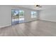 Bedroom with balcony access and wood-look floors at 2120 N 125Th Ave, Avondale, AZ 85392