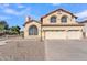 Two-story house with a three-car garage and desert landscaping at 2120 N 125Th Ave, Avondale, AZ 85392
