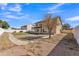 Landscaped backyard with grassy area, walkway, and fire pit at 2120 N 125Th Ave, Avondale, AZ 85392
