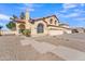 Two-story house with a three-car garage and desert landscaping at 2120 N 125Th Ave, Avondale, AZ 85392