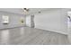 Open living room with hardwood floors and views of backyard at 2120 N 125Th Ave, Avondale, AZ 85392