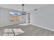 Dining room with hardwood floors and modern light fixture at 2120 N 125Th Ave, Avondale, AZ 85392