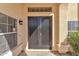 Dark-stained double front doors with a keypad lock at 2120 N 125Th Ave, Avondale, AZ 85392
