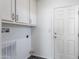 Laundry room with built-in cabinets and a door to exterior at 7750 E Broadway Rd # 723, Mesa, AZ 85208
