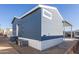 Side view of the manufactured home showcasing rear entrance and AC unit at 7750 E Broadway Rd # 723, Mesa, AZ 85208