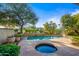 Inviting pool and spa surrounded by stone patio at 7878 E Gainey Ranch Rd # 25, Scottsdale, AZ 85258