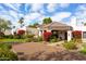 Stunning Spanish-style home with a landscaped front yard and a large driveway at 8530 E Pepper Tree Ln, Scottsdale, AZ 85250