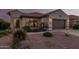 Front view of a charming house with nicely landscaped yard and a two-car garage at 15709 W Roanoke Ave, Goodyear, AZ 85395