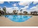 Inviting community pool with surrounding lounge chairs at 15709 W Roanoke Ave, Goodyear, AZ 85395