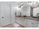 Modern bathroom with double sinks, granite countertop, and white cabinetry at 17197 W Thousand Oaks St, Surprise, AZ 85388