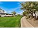 Community pathway with green lawns, trees, and homes in the background at 17197 W Thousand Oaks St, Surprise, AZ 85388