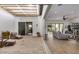 Relaxing courtyard with shaded sitting area, wood furniture, and sliding glass doors to the interior at 17197 W Thousand Oaks St, Surprise, AZ 85388