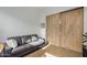 Den or flex space with sliding barn doors and a gray couch at 17197 W Thousand Oaks St, Surprise, AZ 85388