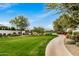 Community green space with walking paths and views of the golf course at 17197 W Thousand Oaks St, Surprise, AZ 85388