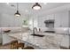 Modern kitchen featuring granite countertops, white cabinetry, and a center island with bar seating at 17197 W Thousand Oaks St, Surprise, AZ 85388