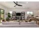Bright and spacious living room with comfortable seating, entertainment center, and open concept access to the kitchen at 17197 W Thousand Oaks St, Surprise, AZ 85388