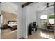Home office with a desk, chair, and view of the adjacent main bedroom at 17197 W Thousand Oaks St, Surprise, AZ 85388