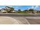 Street view of the community with green lawns and homes at 17197 W Thousand Oaks St, Surprise, AZ 85388