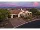 Single-story home with a two-car garage and a view of the mountains in the background at 17404 E Monument Ct, Rio Verde, AZ 85263