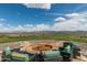 Stone firepit with seating offering scenic mountain views at 17404 E Monument Ct, Rio Verde, AZ 85263