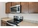 Stainless steel appliances and granite countertops in this modern kitchen at 17807 W Encinas Ln, Goodyear, AZ 85338