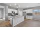 Modern kitchen with island, white cabinets, gray countertops at 17840 W Encinas Ln, Goodyear, AZ 85338