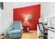 Bright office features a red accent wall and ample workspace at 3301 S Goldfield Rd # 1009, Apache Junction, AZ 85119