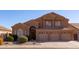 Two-story house with a three-car garage and manicured landscaping at 16847 S 13Th Way, Phoenix, AZ 85048