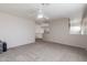 Spacious bonus room with carpeted floors and ceiling fan at 16847 S 13Th Way, Phoenix, AZ 85048