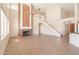 Open living room with high ceilings, fireplace, and tile floors at 16847 S 13Th Way, Phoenix, AZ 85048