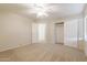 Bedroom with ceiling fan, closet, and access to another room at 16847 S 13Th Way, Phoenix, AZ 85048