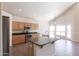 Kitchen with an island, stainless steel appliances, and wood cabinets at 16847 S 13Th Way, Phoenix, AZ 85048