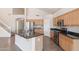 Kitchen boasts a large island, wood cabinets, and granite countertops at 16847 S 13Th Way, Phoenix, AZ 85048