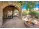 Stone patio with archways, dining table and fire pit at 27440 N Alma School Pkwy # 33-1, Scottsdale, AZ 85262