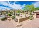 Landscaped front yard with desert plants and brick pavers leading to the home at 27440 N Alma School Pkwy # 33-1, Scottsdale, AZ 85262